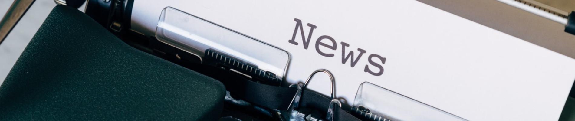 Typewriter with a sheet of paper showing the word "News".
